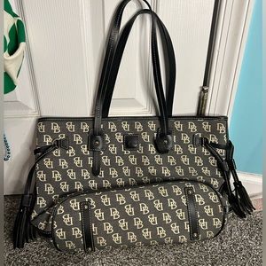 Dooney & Butke Black purse with ivory color logo pattern. Pink interior